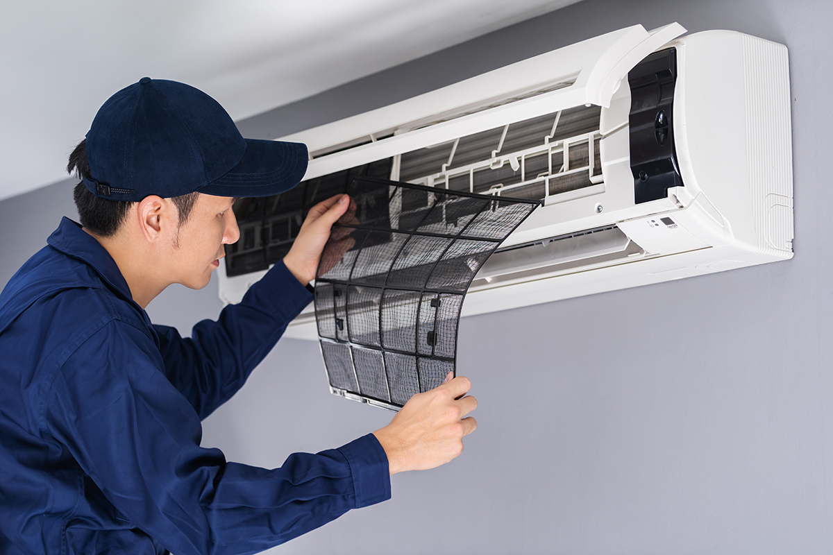 technician service removing air filter of the air conditioner for cleaning